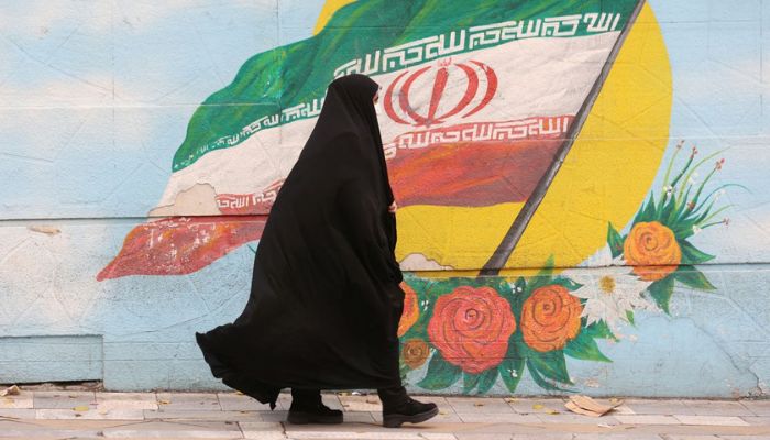 A woman walks after the morality police shut down in a street in Tehran, Iran December 6, 2022.— Reuters
