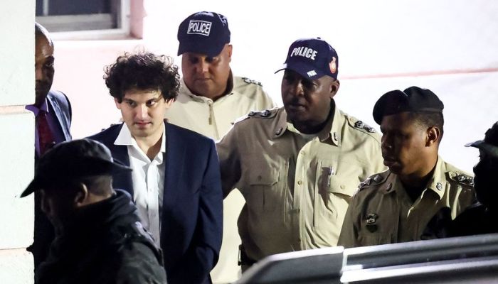Sam Bankman-Fried, who founded and led FTX until a liquidity crunch forced the cryptocurrency exchange to declare bankruptcy, is escorted out of the Magistrate Court building, last month he was arrested after being criminally charged by US prosecutors, in Nassau, Bahamas December 13, 2022.— Reuters