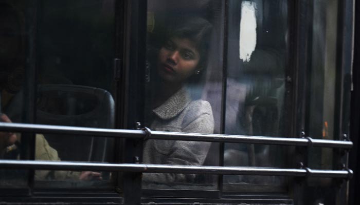 In this photograph taken on December 8, 2022, a woman commutes in a Delhi Transport Corporation bus in New Delhi. — AFP