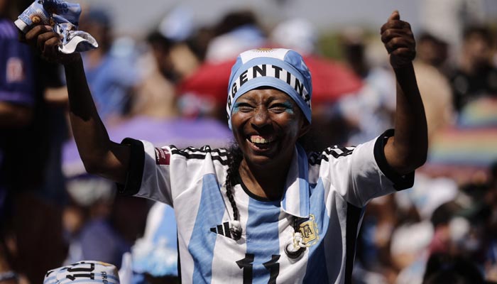 A fan of Argentina reacts while watching the live broadcast of the Qatar 2022 World Cup semi-final football match between Argentina and Croatia at the Francisco Seeber square in Buenos Aires on December 13, 2022. — AFP