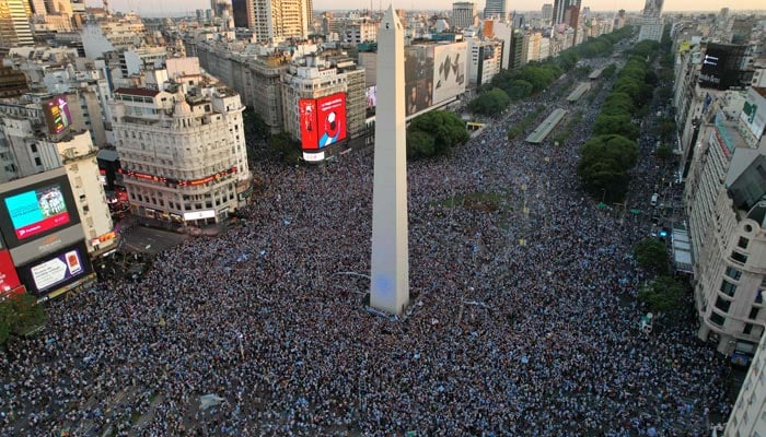 In this aerial view, fans of Argentina celebrate their team´s victory after the Qatar 2022 World Cup semifinal football match between Croatia and Argentina at the Obelisk in Buenos Aires on December 13, 2022. — AFP