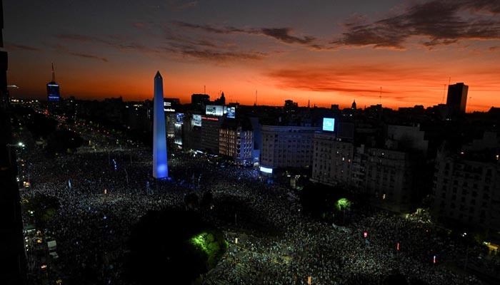 In this aerial view fans of Argentina celebrate their team´s victory after the Qatar 2022 World Cup semifinal football match between Croatia and Argentina at the Obelisk in Buenos Aires on December 13, 2022. — AFP