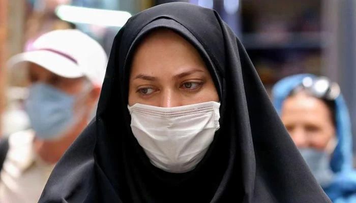 Iranian woman wearing a protective mask amid the COVID-19 pandemic, shops in the capital Tehran. — AFP/File
