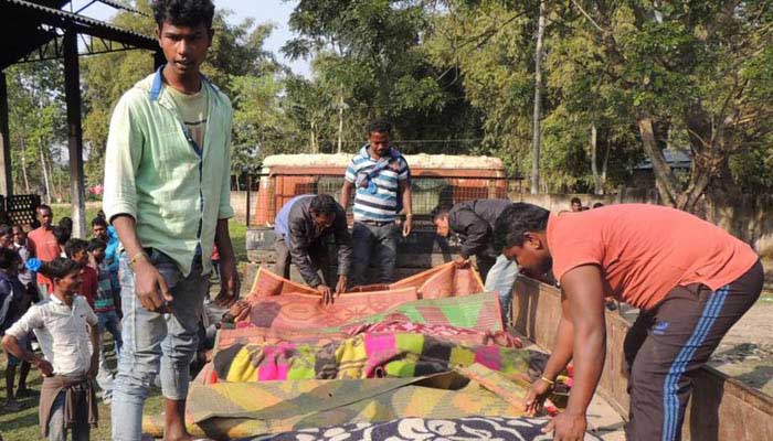 Villagers arranging the bodies of victims who died after allegedly drinking toxic liquor, in Assams Golaghat district on Feb 22, 2019. — AFP