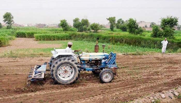 A farmer driving a tractor on his farms. — Reuters/File