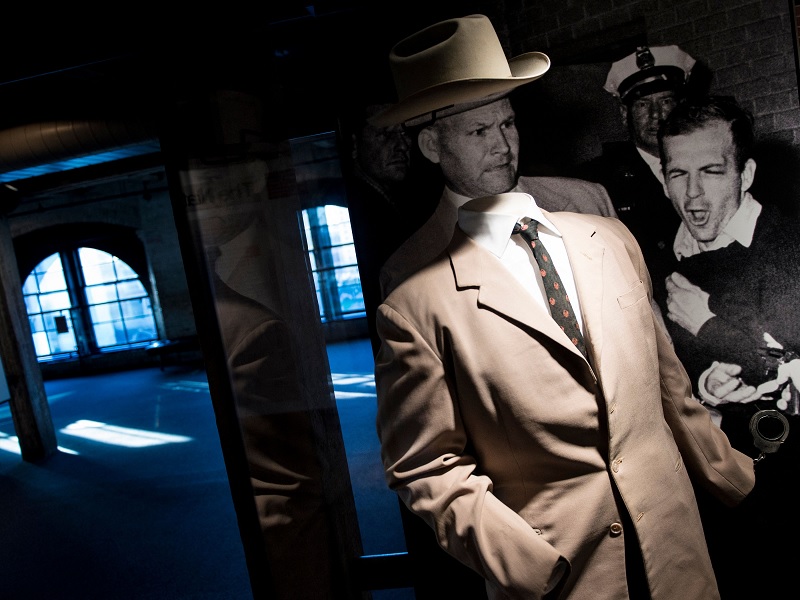 In this file photo taken on October 08, 2013, the suit worn by Dallas Homicide Detective Jim Leavelle is displayed in the Sixth Floor Museum formally the site of the Texas School Book Depository in front of a photo of Leavelle (L) during the murder of Lee Harvey Oswald by Jack Ruby, in Dallas, Texas.— AFP