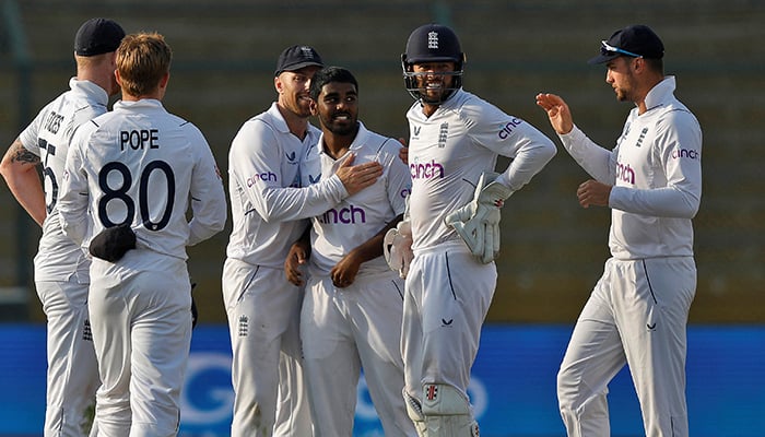 Cricket - Third Test - Pakistan v England - National Stadium Karachi, Pakistan - December 17, 2022. Englands Rehan Ahmed is congratulated by his teammates after taking the wicket of Pakistans Faheem Ashraf. — Reuters