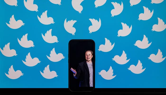 The picture shows Twitter CEO Elon Musks photo on a mobile phone. — AFP/File