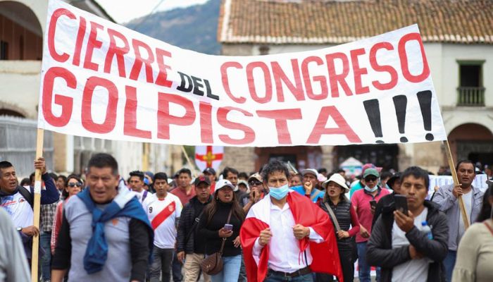 Demonstrators carry a sign reading Closure of the coup Congress, amid violent protests following the ousting and arrest of former President Pedro Castillo, in Ayacucho, Peru December 15, 2022.— Reuters