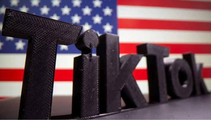 A 3D printed Tik Tok logo is seen in front of U.S. flag in this illustration taken October 6, 2020. Picture taken October 6, 2020.— Reuters