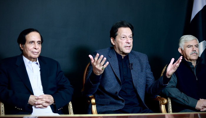 PTI Chairman Imran Khan (centre) addresses supporters while seated alongside CM Punjab Chaudhry Parvez Elahi (left) and KP CM Mahmood Khan. — Twitter/PTIofficial