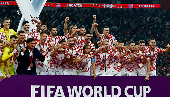 Soccer Football - FIFA World Cup Qatar 2022 - Third-Place Playoff - Croatia v Morocco - Khalifa International Stadium, Doha, Qatar - December 17, 2022, Croatia players celebrate with their medals on stage as they finish in third place. — Reuters