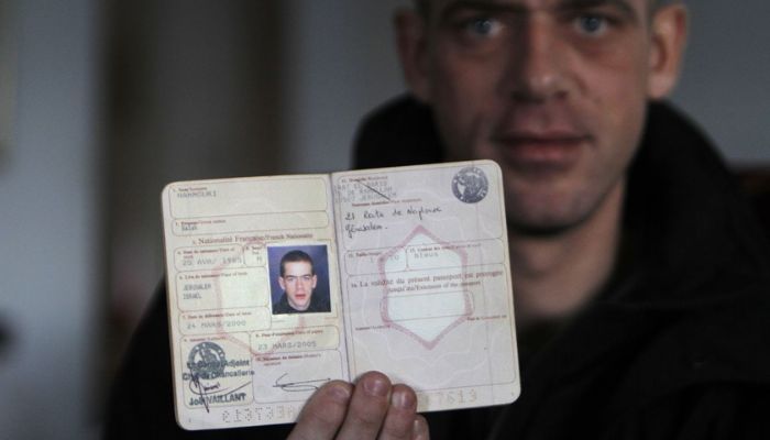 Salah Hamouri, 26, one of the 550 Palestinian prisoners freed to complete a deal in which Israel released 1,027 prisoners for soldier Gilad Shalit who was held captive in the Gaza Strip for over five years, shows his French passport during an interview with Reuters in the West Bank neighbourhood of Dahiyet al-Barid, on the outskirts of Jerusalem December 19, 2011.— Reuters