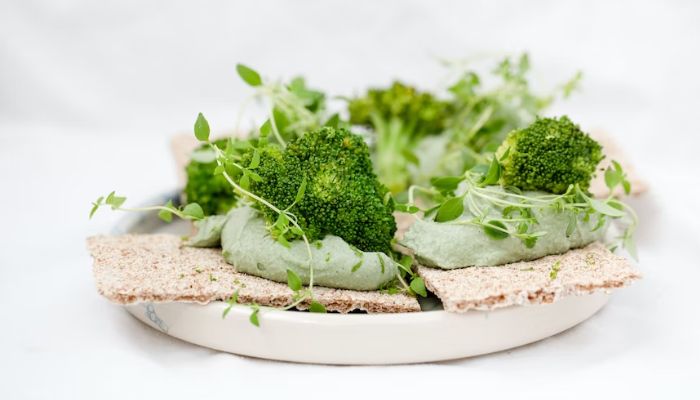 Healthy appetizer with spirulina hummus, broccoli & herbs.— Unsplash
