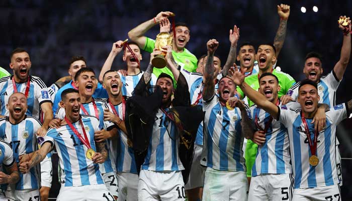 Argentinas Lionel Messi lifts the World Cup trophy alongside teammates as they celebrate after winning the World Cup on December 18, 2022. — Reuters