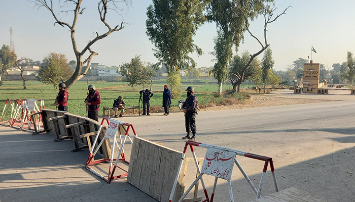 Soldiers stand guard on a road leading to the cantonment area in Bannu, December 20, 2022. — Reuters