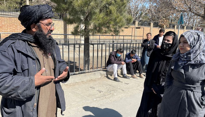 A member of Taliban speaks with female students outside the Kabul Education University in Kabul, Afghanistan, February 26, 2022. — Reuters