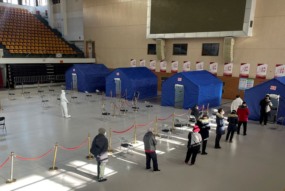 People line up at a makeshift fever clinic set up inside a stadium, amid the coronavirus disease (COVID-19) outbreak in Beijing, China December 19, 2022.— Reuters