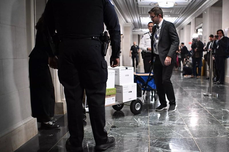 Staff members cart documents for a hearing by the House Ways and Means Committee to discuss tax returns from former US president Donald Trump on December 20, 2022.— AFP