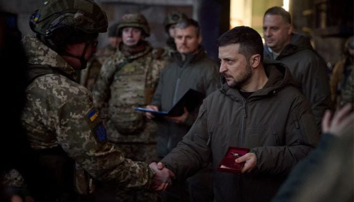 Ukraines President Volodymyr Zelenskiy awards a Ukrainian service member at a position in the frontline town of Bakhmut, amid Russias attack on Ukraine, in Donetsk region, Ukraine December 20, 2022.— Reuters