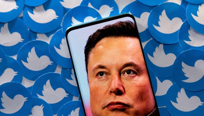 An image of Elon Musk is seen on a smartphone placed on printed Twitter logos in this picture illustration taken April 28, 2022. — Reuters