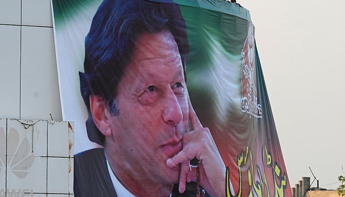 A giant portrait of Imran Khan is seen during an anti-govt rally in Rawalpindi on Nov 26, 2022. — AFP