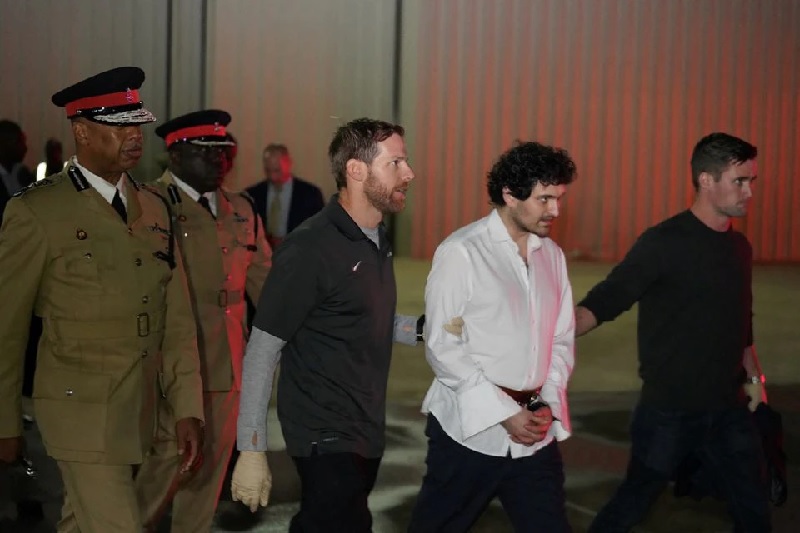 Sam Bankman-Fried, founder and former CEO of cryptocurrency exchange FTX, is walked in handcuffs to a plane during his extradition to the United States at Lynden Pindling international airport in Nassau, Bahamas December 21, 2022.— Reuters