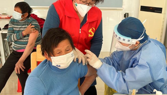 A medical worker administers a dose of a vaccine against coronavirus disease (COVID-19) to an elderly resident, during a government-organized visit to a vaccination center in Zhongmin village on the outskirts of Shanghai, China December 21, 2022.— Reuters