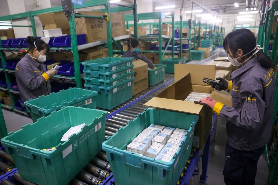 Workers sort medicines at a logistics centre of China Resources Pharmaceutical Group Limited, amid the coronavirus disease (COVID-19) outbreaks in Beijing, China December 19, 2022.— Reuters