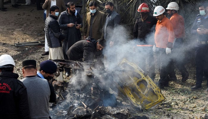 Rescue workers and police officers gather at the site of a suicide car bombing in Islamabad, Pakistan December 23, 2022. — Reuters