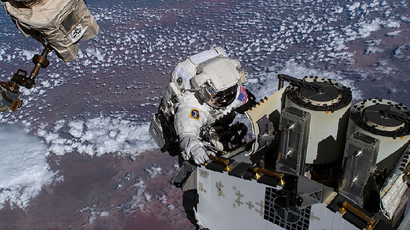 NASA spacewalker Josh Cassada prepares the station’s fourth roll-out solar array for its installation and deployment as the orbiting lab flew above the Atlantic Ocean off the coast of Namibia.— NASA