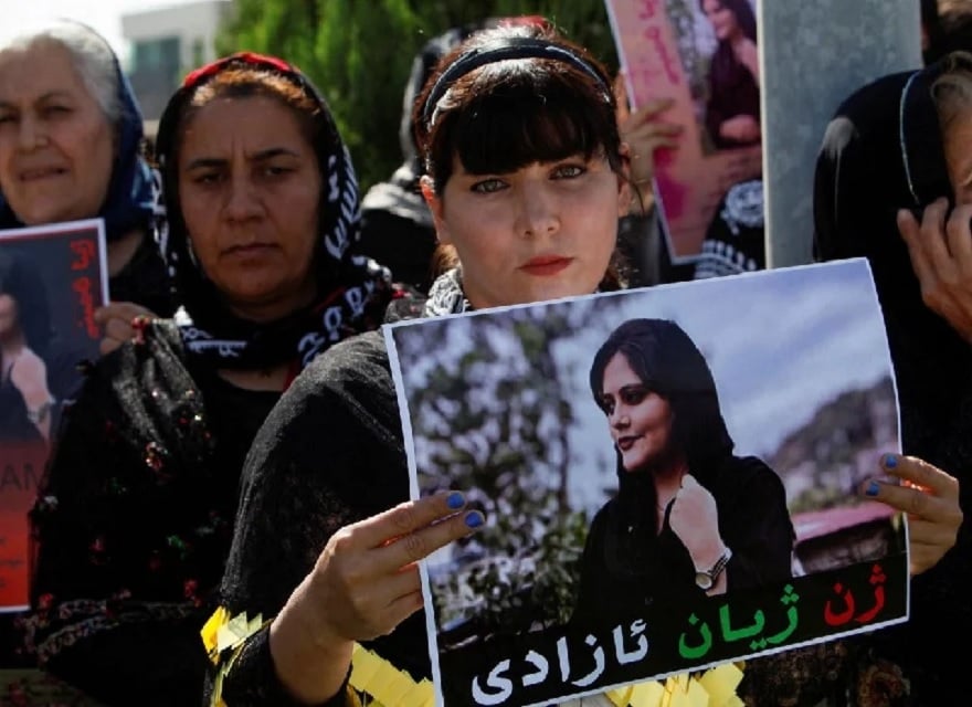 A woman holds a placard during a protest following the death of Mahsa Amini in front of the United Nations headquarters in Erbil, Iraq September 24, 2022. — Reuters