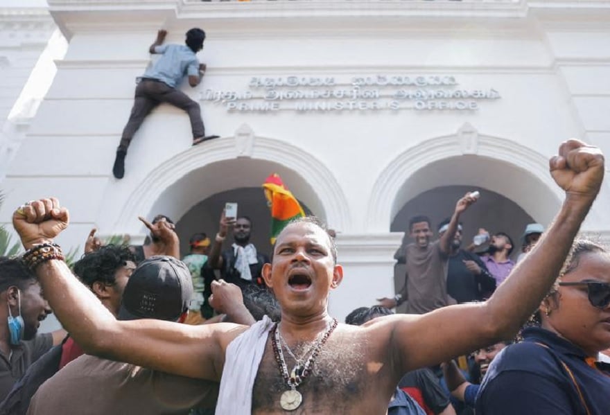 Demonstrators celebrate after they entered into Sri Lankan Prime Minister Ranil Wickremasinghes office during a protest demanding for his resignation, after President Gotabaya Rajapaksa fled, in Colombo, Sri Lanka, July 13.— Reuters