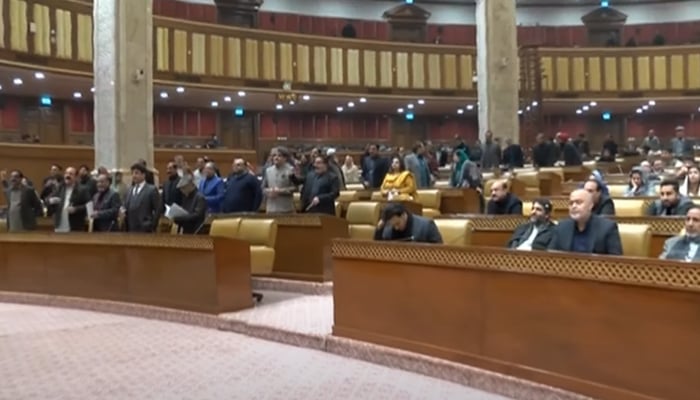 Opposition lawmakers (left) chant slogans against Punjab Chief Minister Parvez Elahi and the provincial government during a session of the Punjab Assembly in Lahore on December 23, 2022. — YouTube/DunyaNews