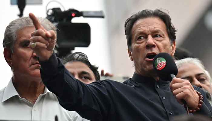 Former prime minister Imran Khan (R) addresses his supporters during an anti-government march towards capital Islamabad, demanding early elections, in Gujranwala on November 1, 2022. —AFP