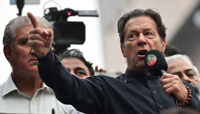 Former prime minister Imran Khan (R) addresses his supporters during an anti-government march towards capital Islamabad, demanding early elections, in Gujranwala on November 1, 2022. —AFP