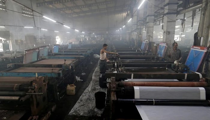 Labourers working at a textile factory. — Reuters/File