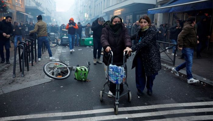 Protestors clash with French police during a demonstration near the Rue dEnghien after gunshots were fired killing and injuring several people in a central district of Paris, France, December 23, 2022.— Reuters