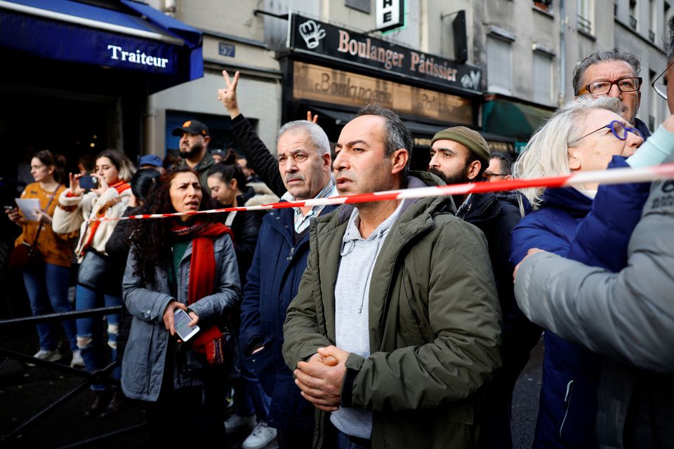 People gather near the Rue dEnghien after gunshots were fired killing and injuring several people in a central district of Paris, France, December 23, 2022. — Reuters