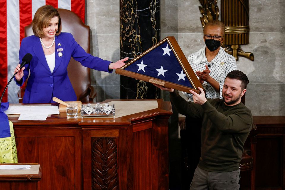 Ukraines President Volodymyr Zelenskiy receives a U.S. flag from U.S. House Speaker Nancy Pelosi (D-CA) during a joint meeting of the U.S. Congress in the House Chamber of the U.S. Capitol in Washington, US, December 21, 2022.— Reuters