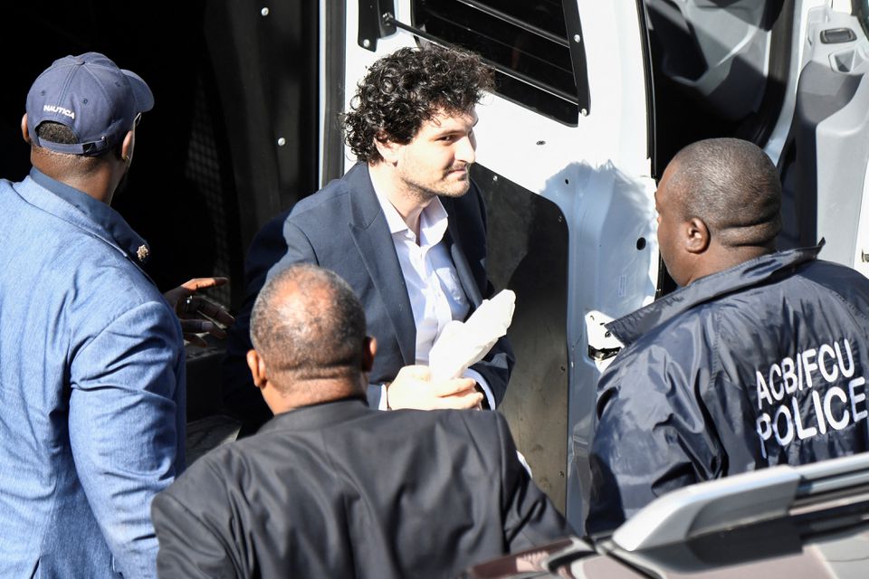 Sam Bankman-Fried, the founder and former CEO of crypto currency exchange FTX, is escorted into the Magistrate Court building in Nassau, Bahamas December 21, 2022.— Reuters