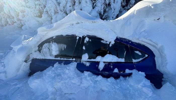 A view of a car covered in snow after heavy snowfall in Regent, North Dakota, U.S. December 23, 2022, in this picture obtained from social media.— TwitterBlakeRafferty1