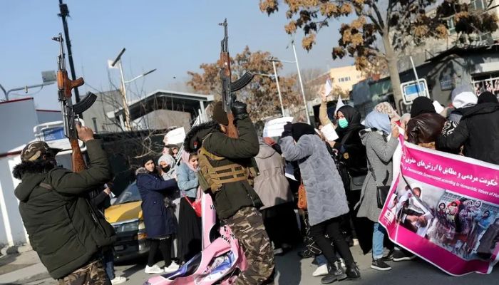 Members of the Taliban forces fire in the air to disperse the Afghan women during a rally to protest against what the protesters say is Taliban restrictions on women, in Kabul, Afghanistan, December 28, 2021. Reuters