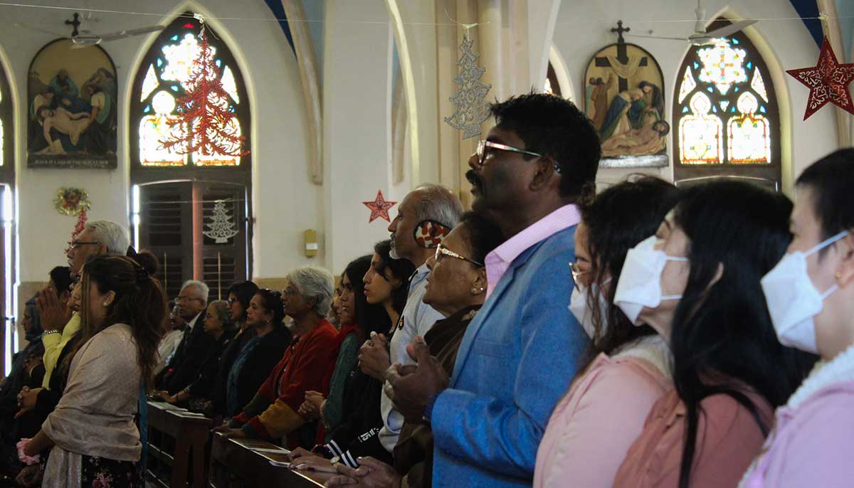 Members of the Christian community pray during the Christmas Day mass.