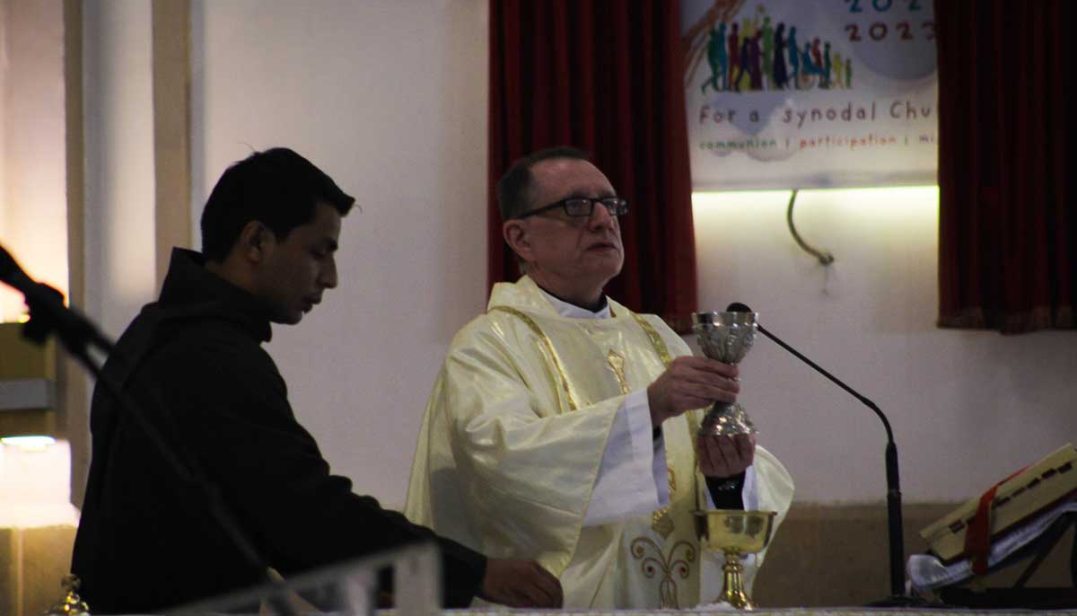 Father James Borges performs rituals of Christmas Day mass.