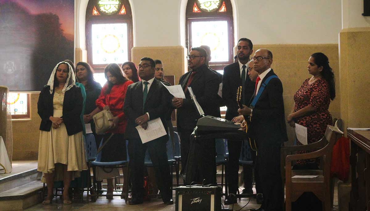 Members of the church choir preparing to sing hymns and carols in between prayers led by the priest during the Christmas Day mass.