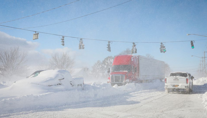 Vehicles are left stranded on the road following a winter storm that hit the Buffalo region — REUTERS