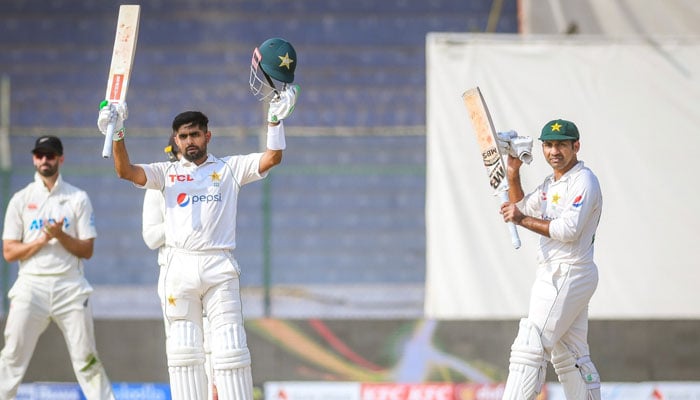 Babar Azam raises his bat as after completing his century while Sarfaraz Ahmed claps for his skipper during Pakistans match against New Zealand at the National Bank Cricket Arena in Karachi. — PCB