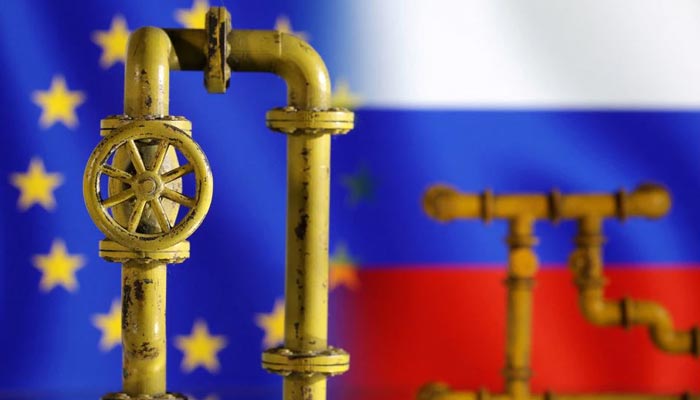Model of natural gas pipeline, EU and Russia flags, July 18, 2022. — Reuters