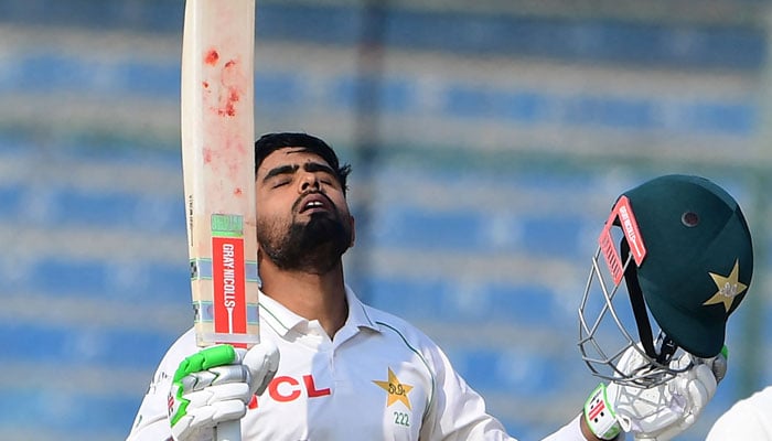 Pakistans captain Babar Azam gestures after scoring a century (100 runs) during the first day of the first cricket Test match between Pakistan and New Zealand at the National Stadium in Karachi on December 26, 2022. — AFP